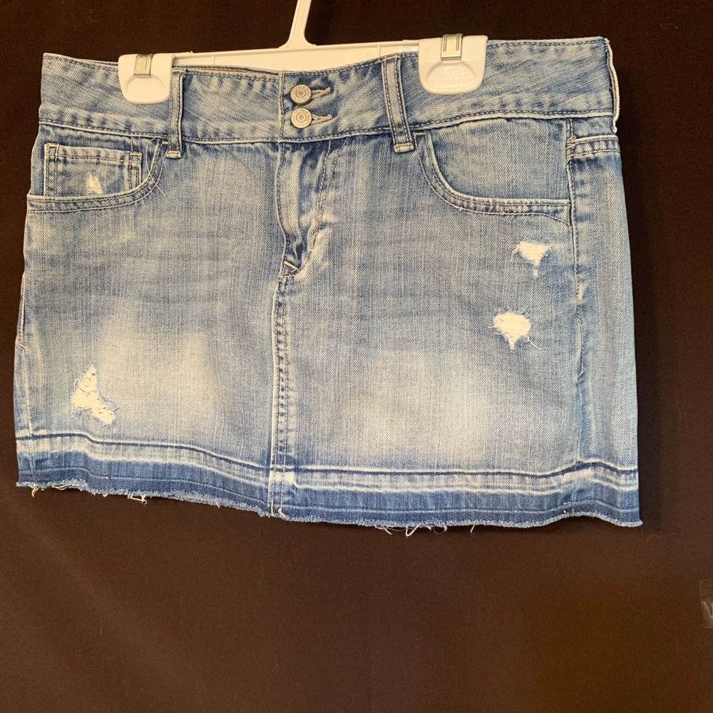 Distressed button fly denim skirt with raw hem. Size 8